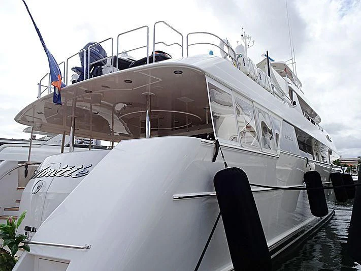 a white boat with blue flags aboard TRUST FUN Yacht for Sale
