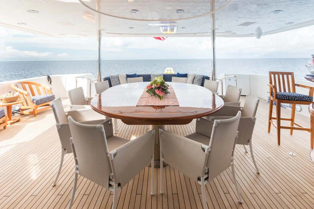 a table and chairs on a balcony aboard TRUST FUN Yacht for Sale