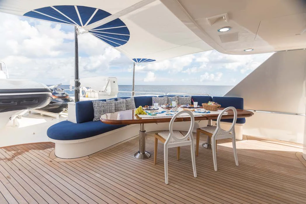 a table and chairs on a deck aboard TRUST FUN Yacht for Sale