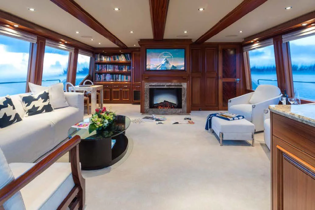 a living room with a fireplace aboard TRUST FUN Yacht for Sale