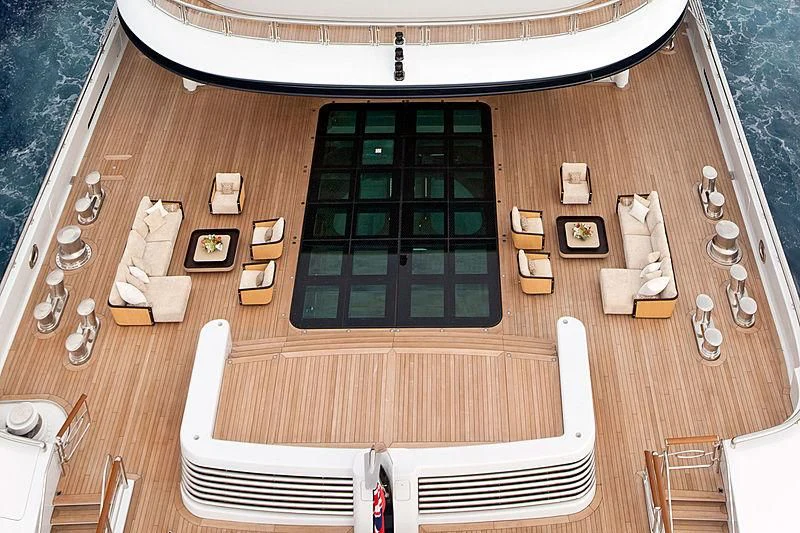 a wooden table with a white chair and a white chair aboard SERENE Yacht for Sale