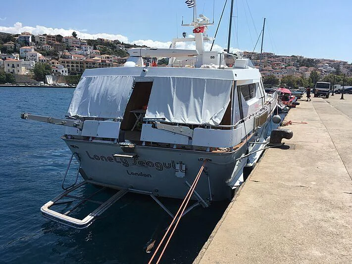 a boat parked on the side of a road aboard LONELY SEAGULL Yacht for Sale
