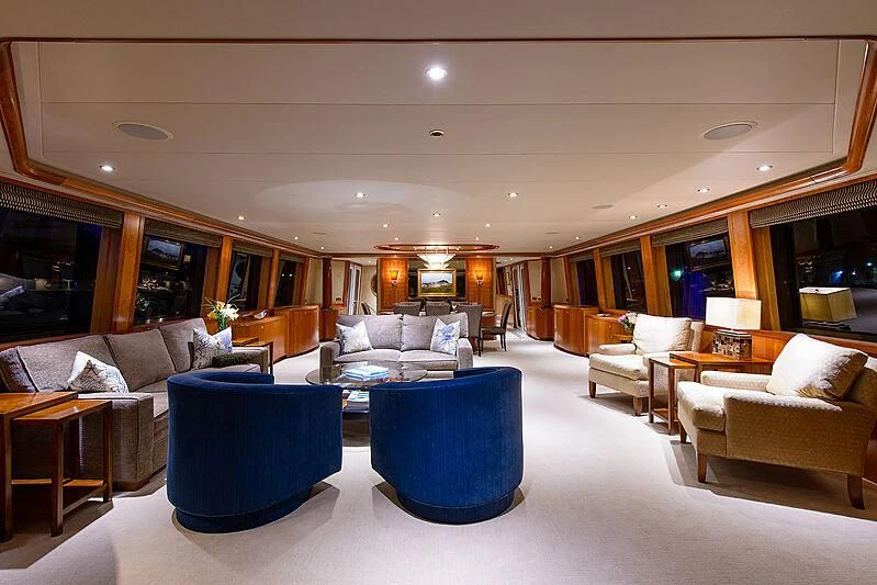 a living room with a blue couch aboard BRAVO ZULU Yacht for Sale