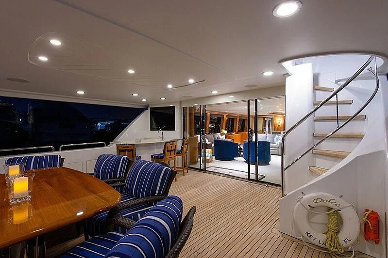 a living room with a large glass door and a staircase aboard BRAVO ZULU Yacht for Sale