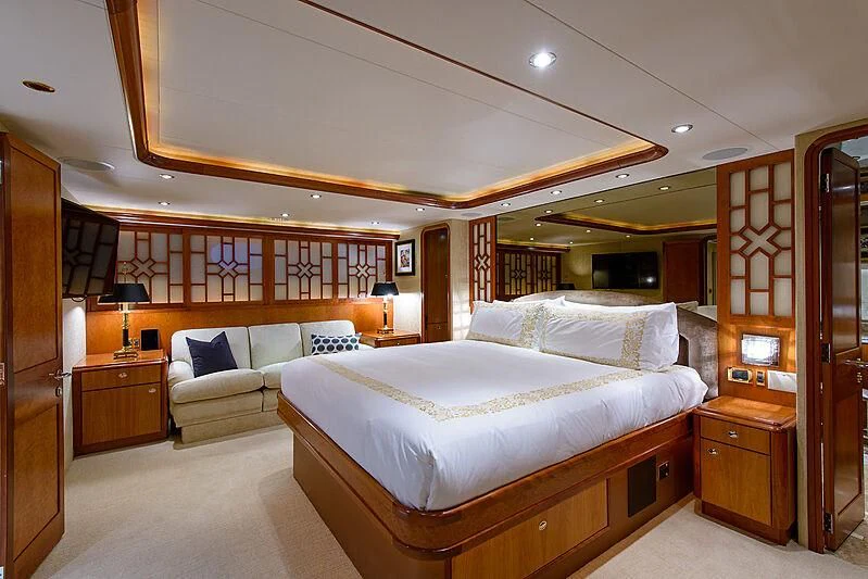 a room with a bed and a couch aboard BRAVO ZULU Yacht for Sale