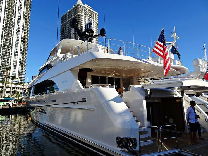 a large white boat with flags aboard FREEDOM Yacht for Sale
