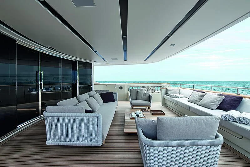 a living room with a large balcony aboard Y4H Yacht for Sale