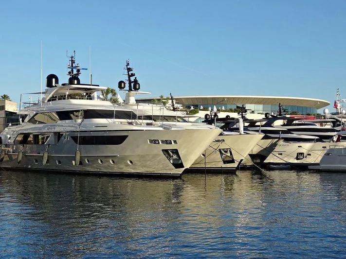 a large white boat in a harbor aboard Y4H Yacht for Sale