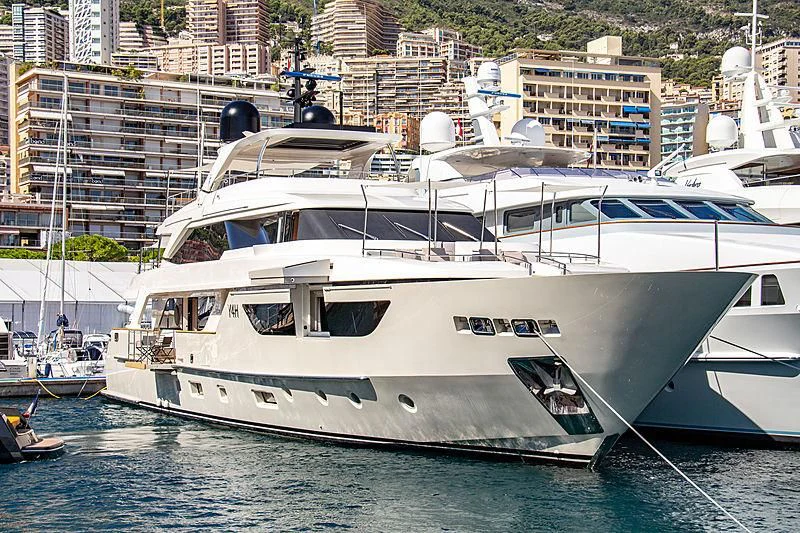 a white yacht in a harbor aboard Y4H Yacht for Sale