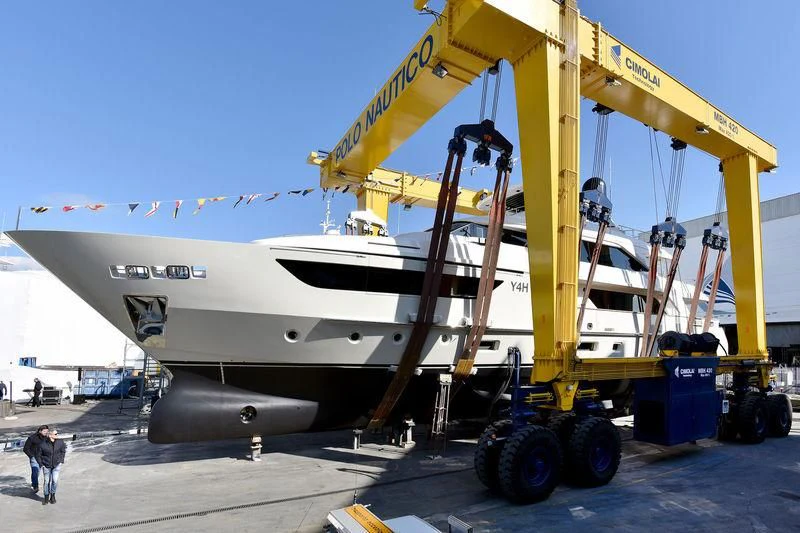 a large yellow machine on a trailer aboard Y4H Yacht for Sale
