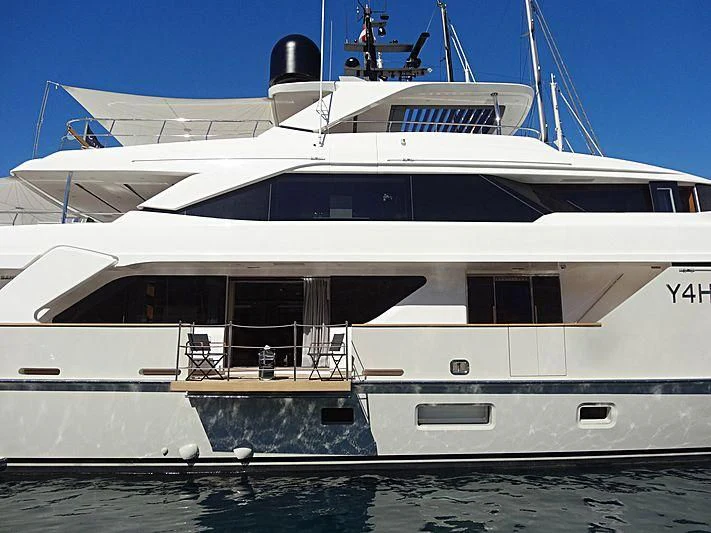 a white yacht with a black and white stripe aboard Y4H Yacht for Sale
