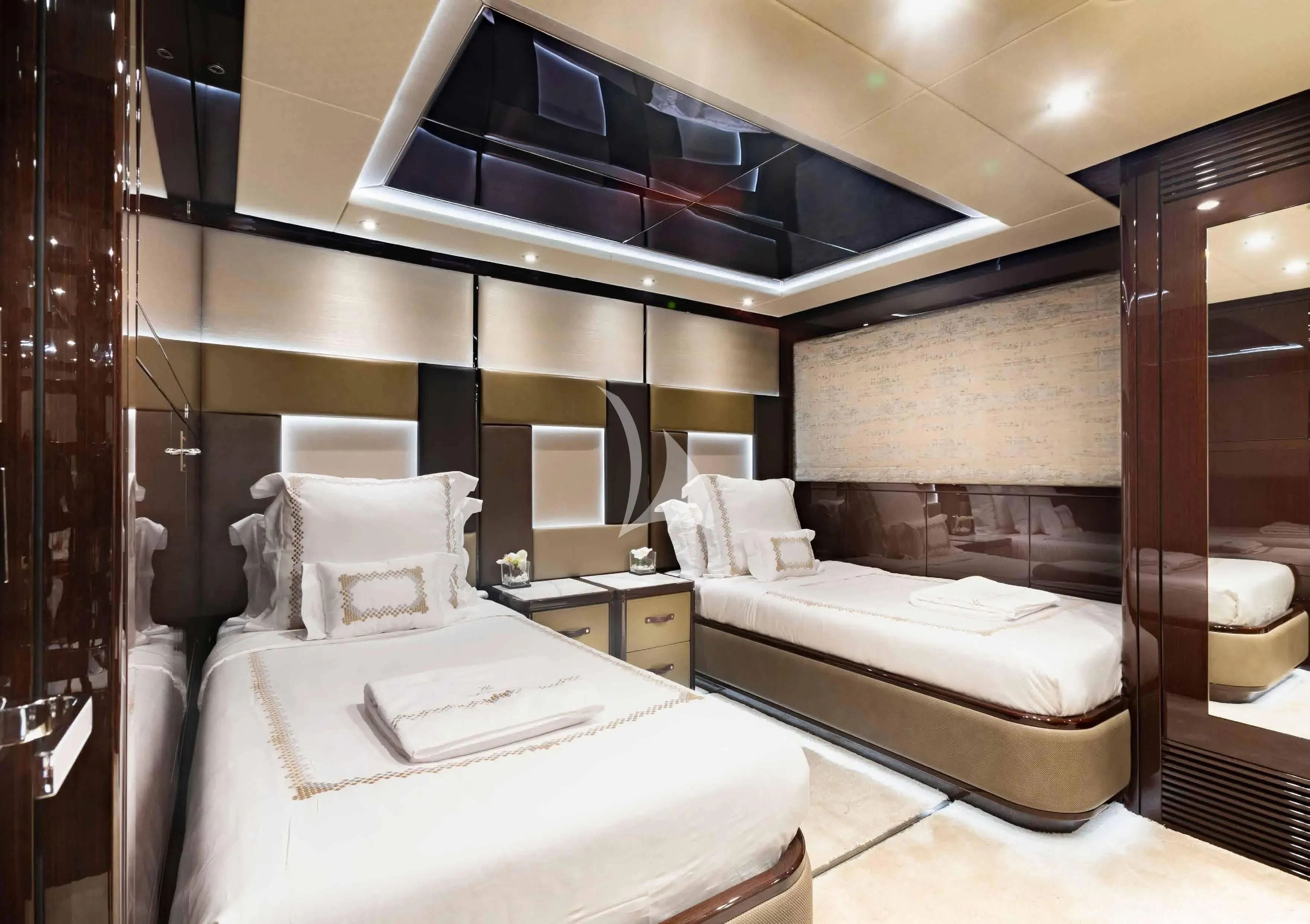 a room with a couple of beds aboard NEXUS Yacht for Charter