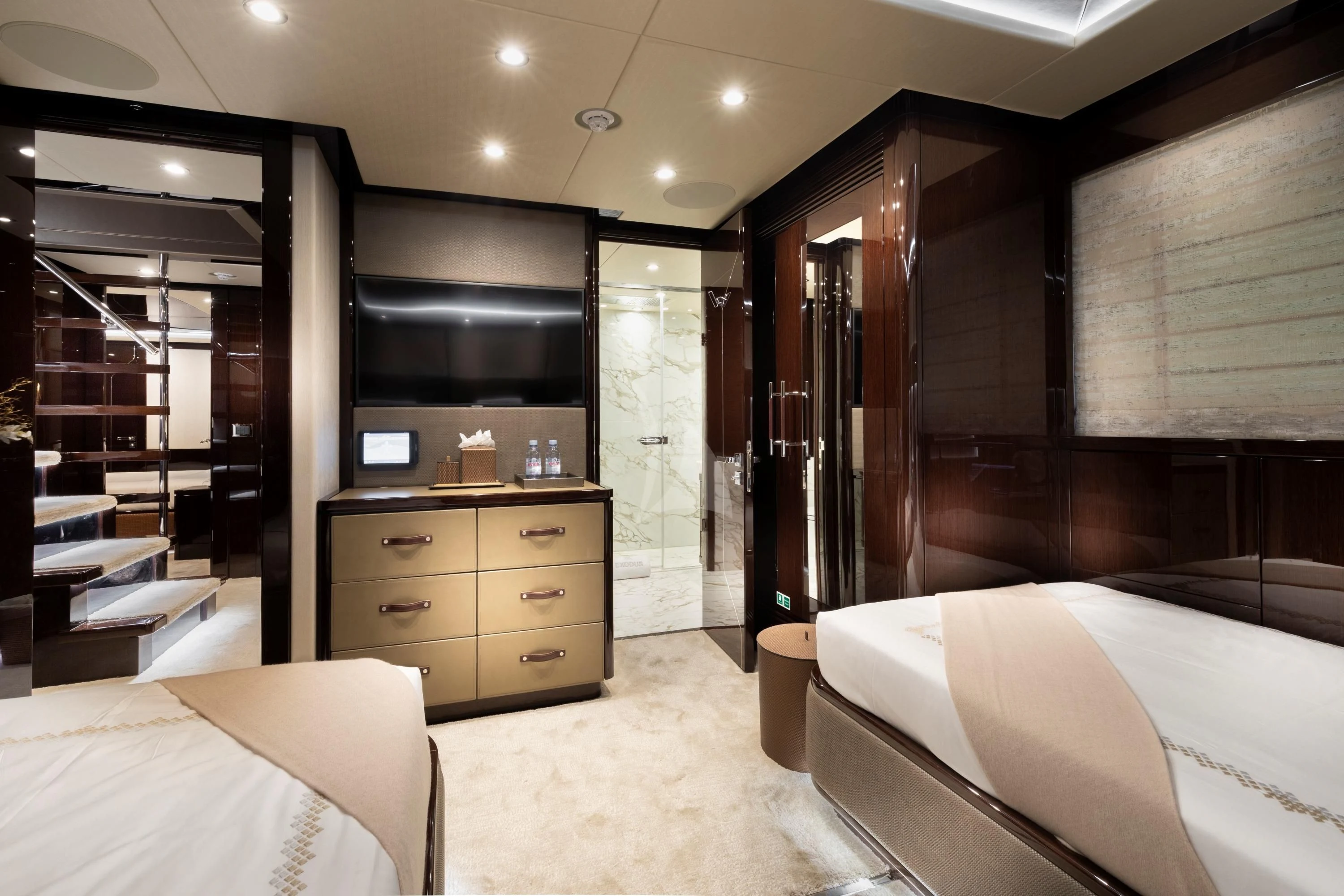 a bedroom with a bed and a desk aboard NEXUS Yacht for Charter