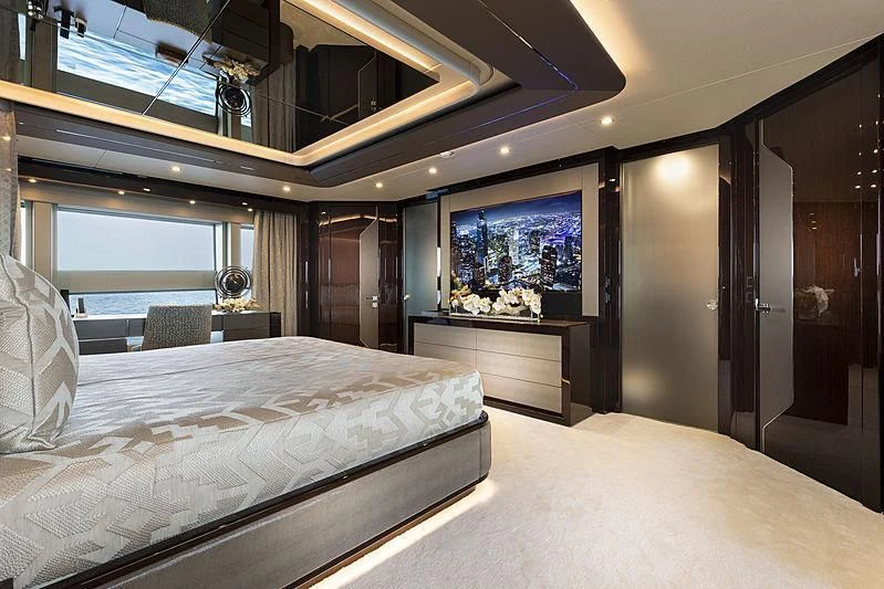 a room with a bed and a tv aboard NEXUS Yacht for Charter