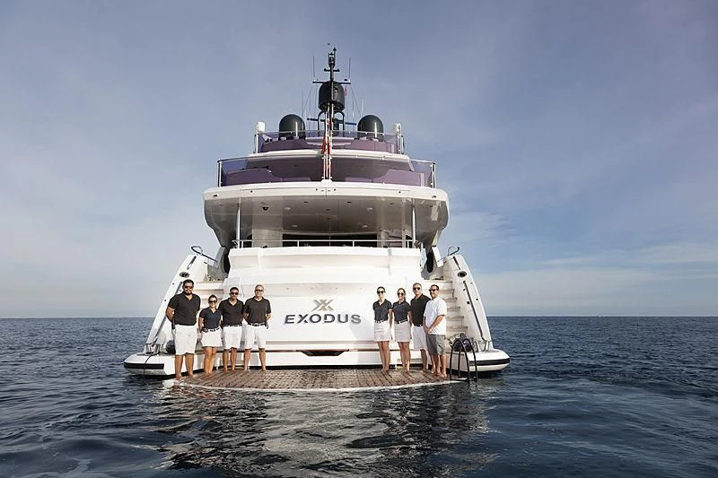 a group of people standing on a boat in the water with Thomas Point Shoal Light in the background aboard NEXUS Yacht for Charter