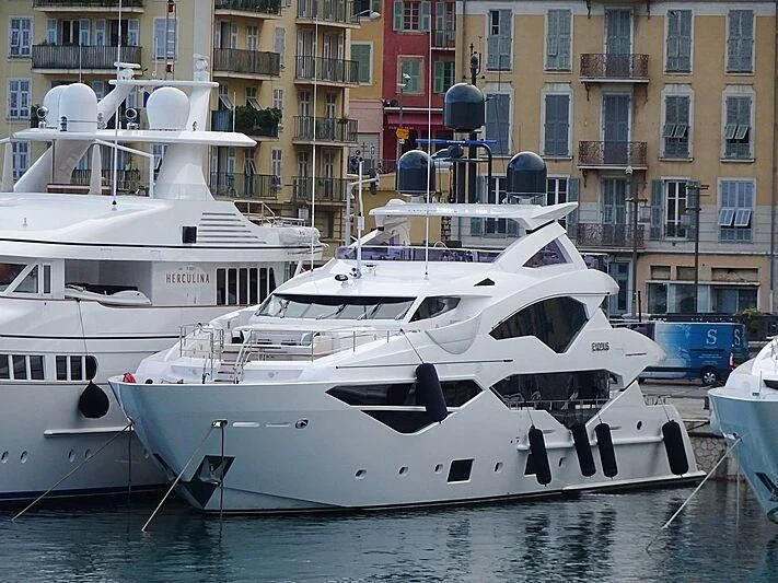 a couple of boats sit in a harbor aboard NEXUS Yacht for Charter