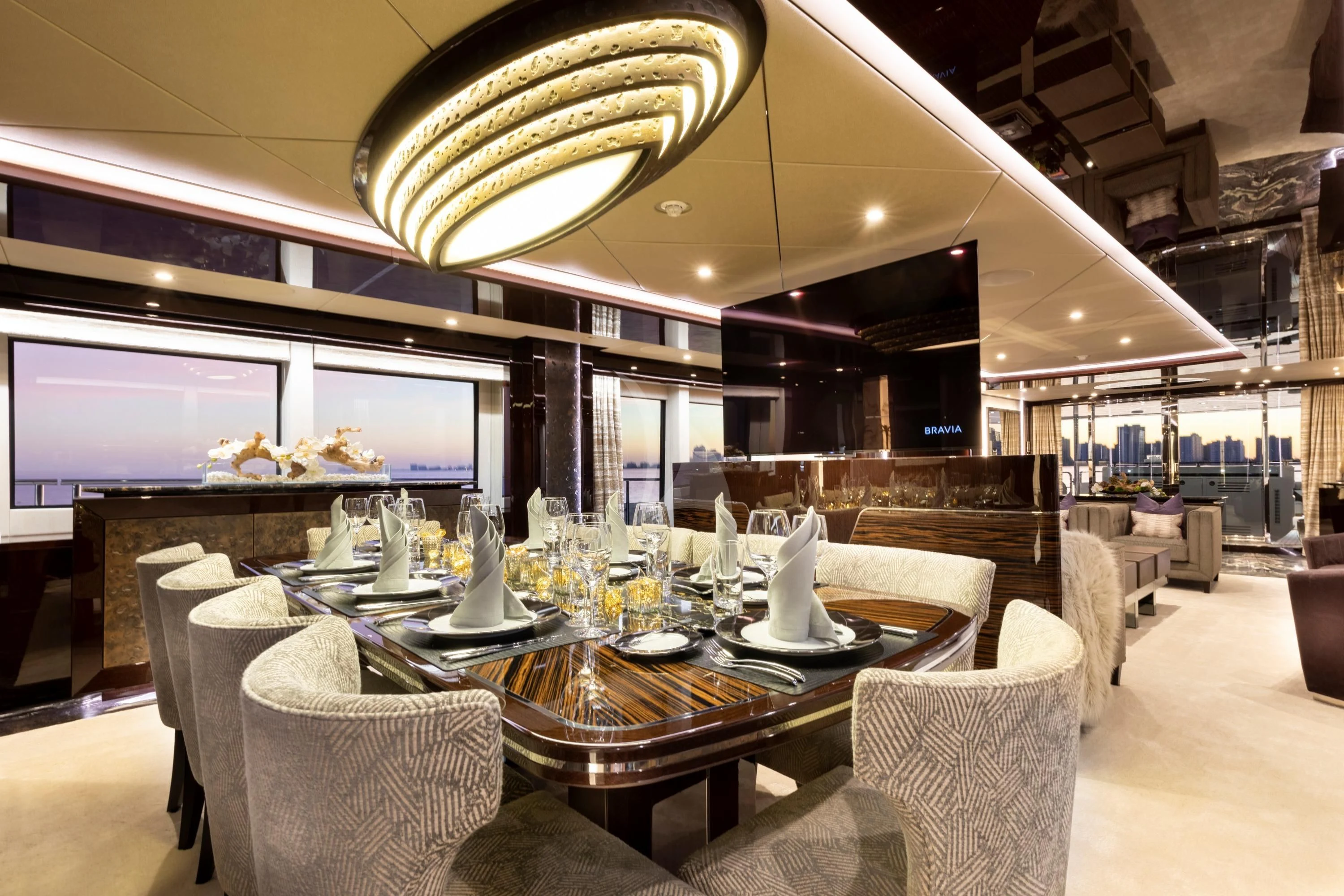 a large room with tables and chairs aboard NEXUS Yacht for Charter