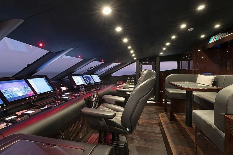 inside of a car with many monitors and chairs and tables aboard NEXUS Yacht for Charter