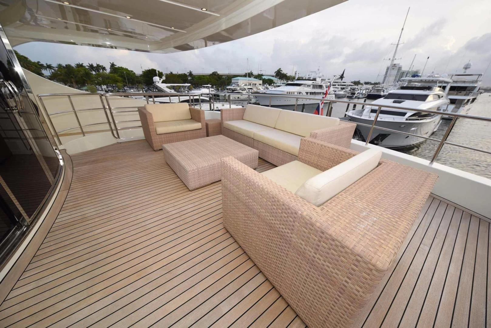 a deck with couches and a boat on it aboard KIMBERLIE Yacht for Sale