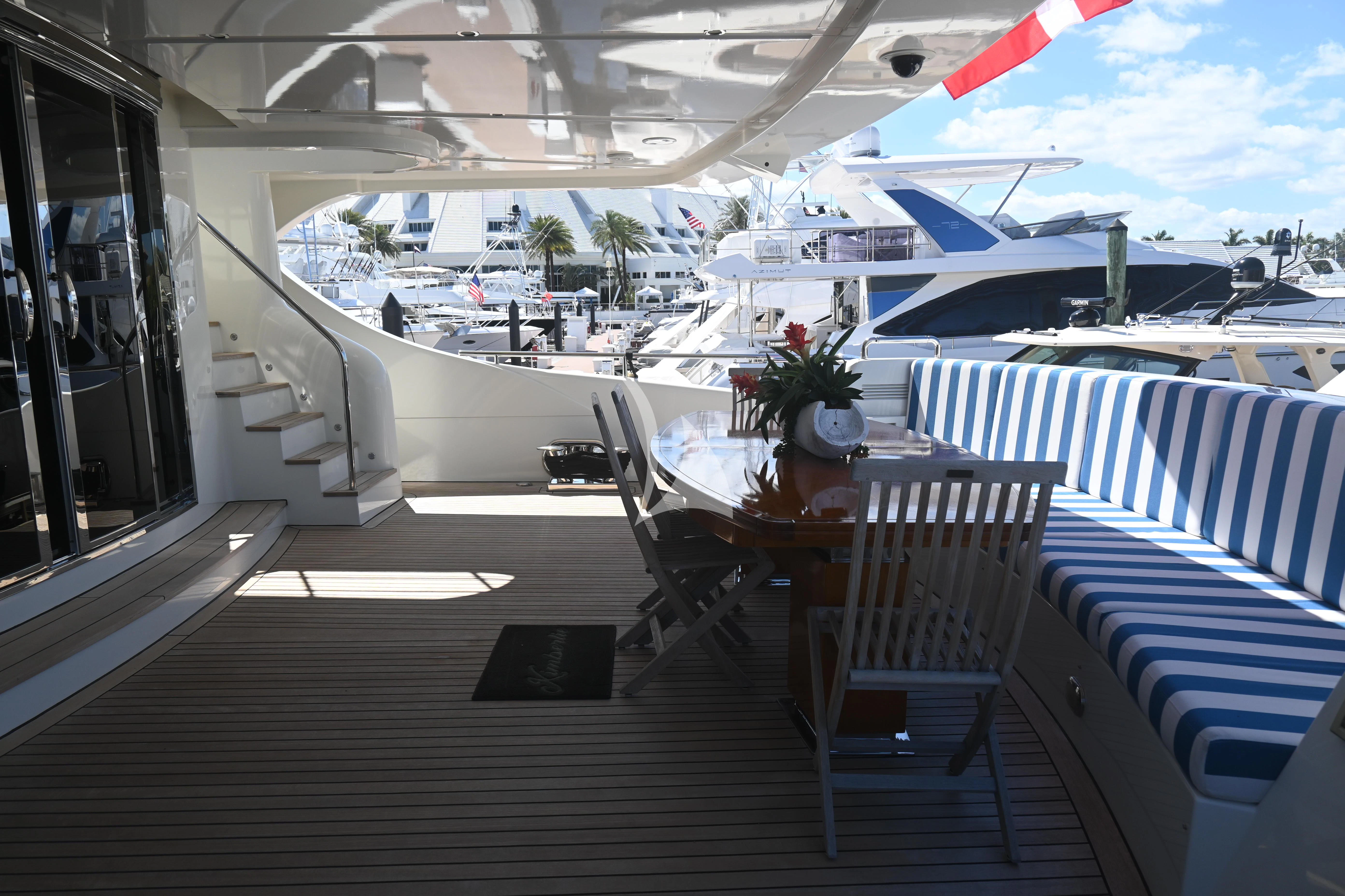 a deck with a table and chairs aboard KIMBERLIE Yacht for Sale