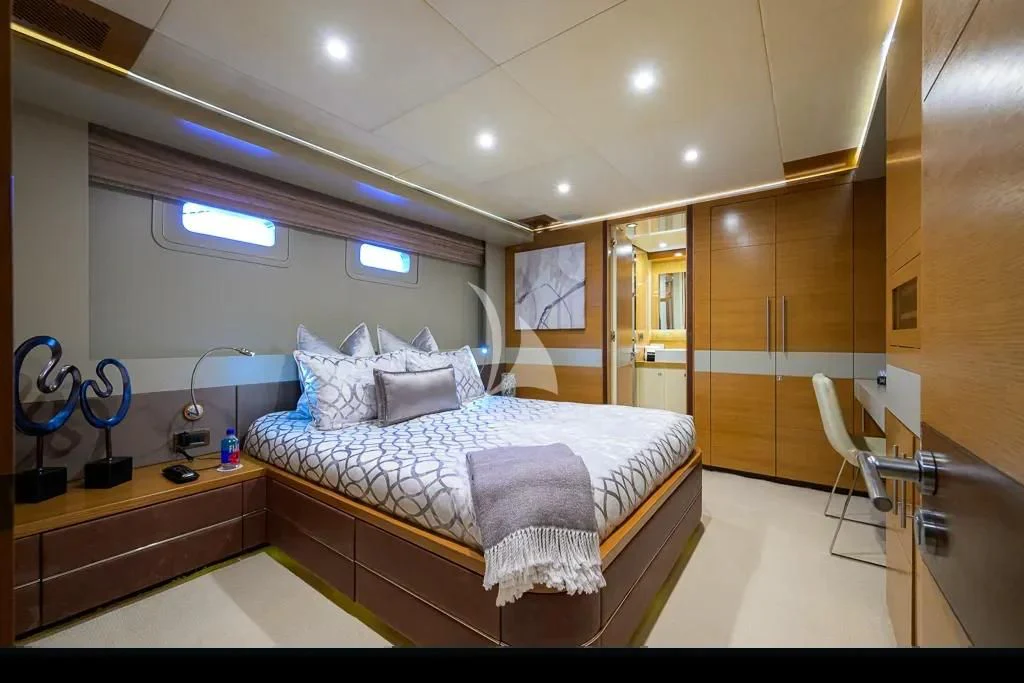a bedroom with a bed and a desk aboard KIMBERLIE Yacht for Sale