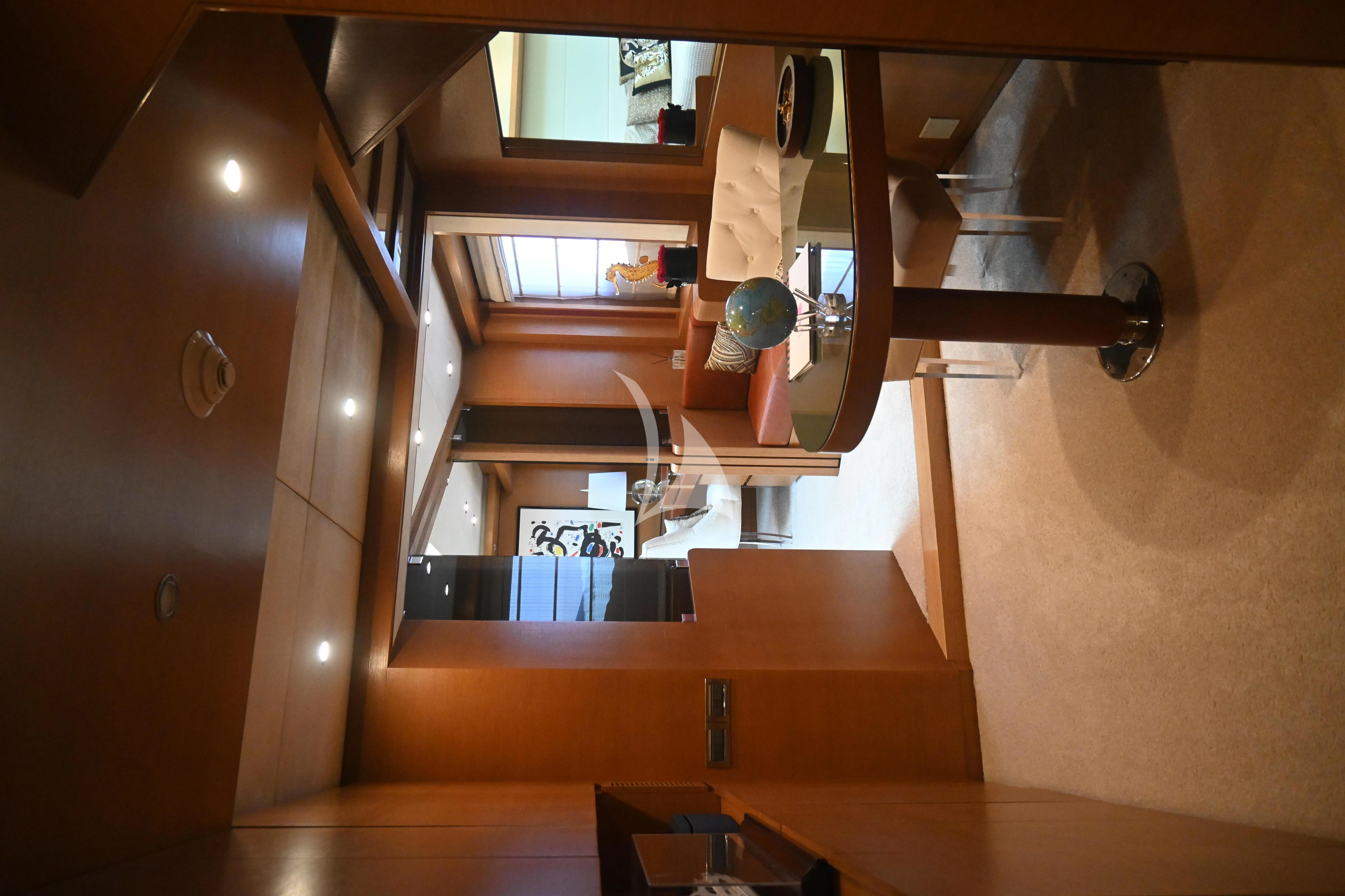 a room with a wood table and a lamp on the wall aboard KIMBERLIE Yacht for Sale