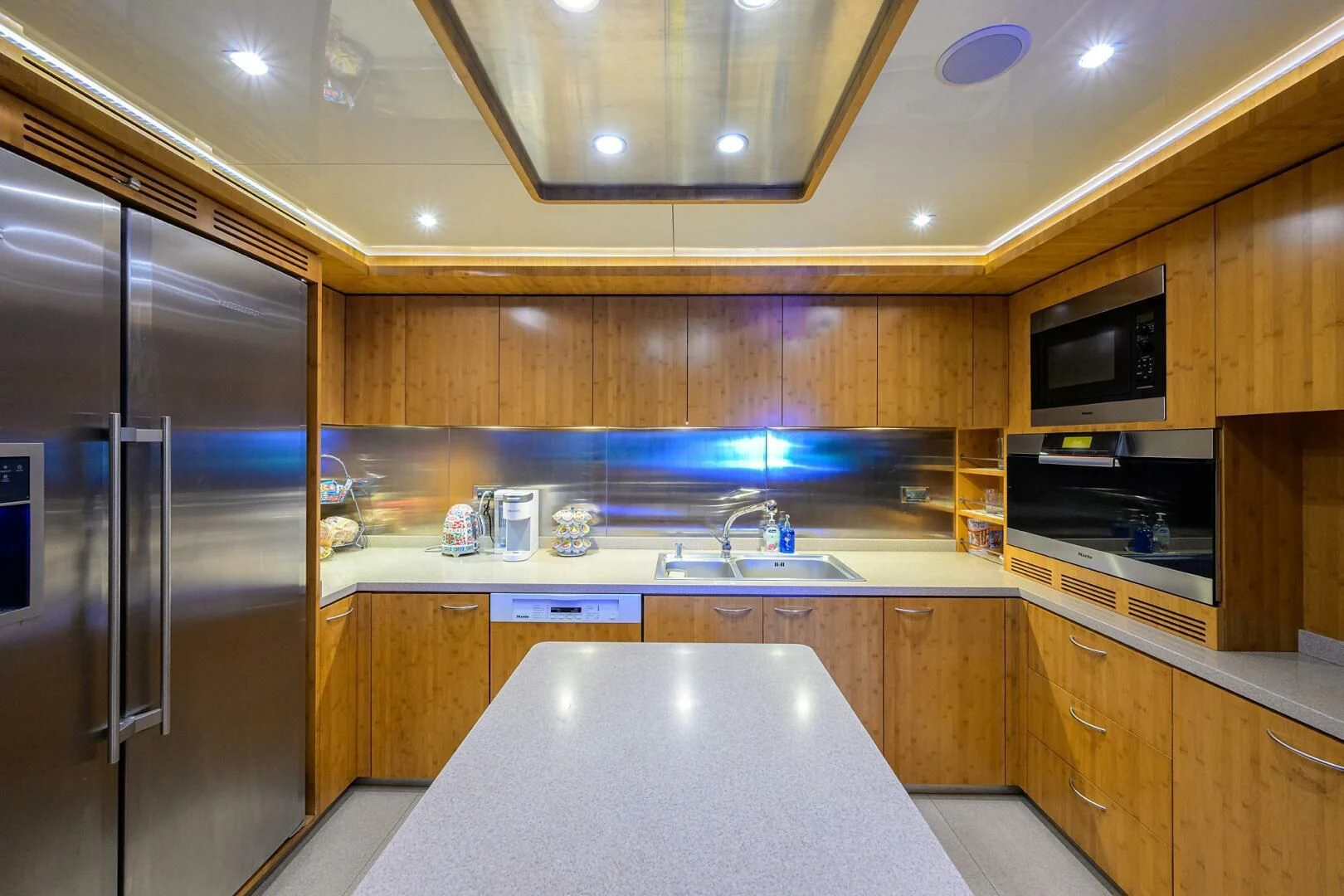 a kitchen with a stainless steel refrigerator aboard KIMBERLIE Yacht for Sale