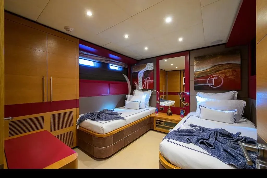 a room with a bed and a mirror aboard KIMBERLIE Yacht for Sale