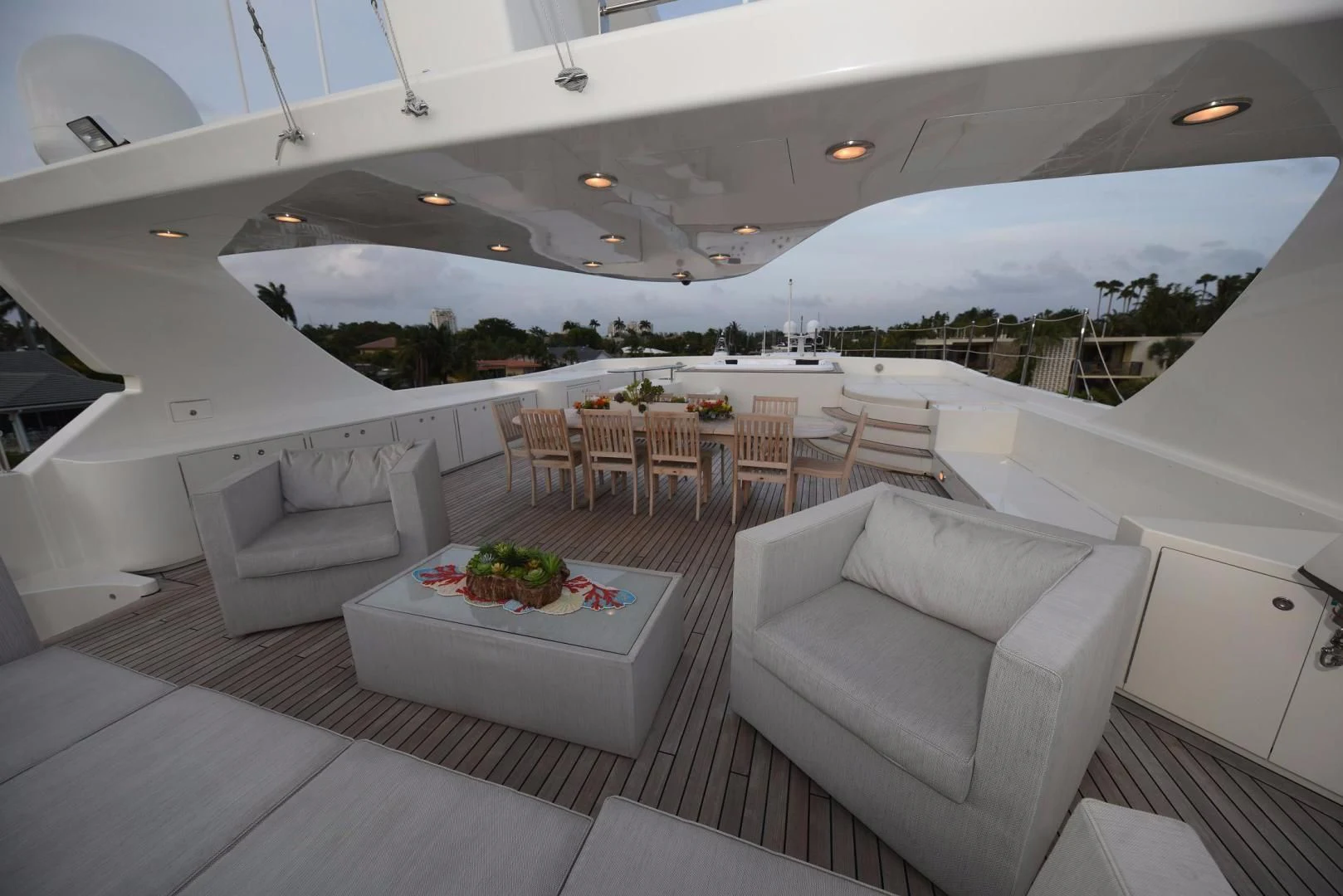 a large white lounge area with a large white lounge chair and a table with a white couch and aboard KIMBERLIE Yacht for Sale