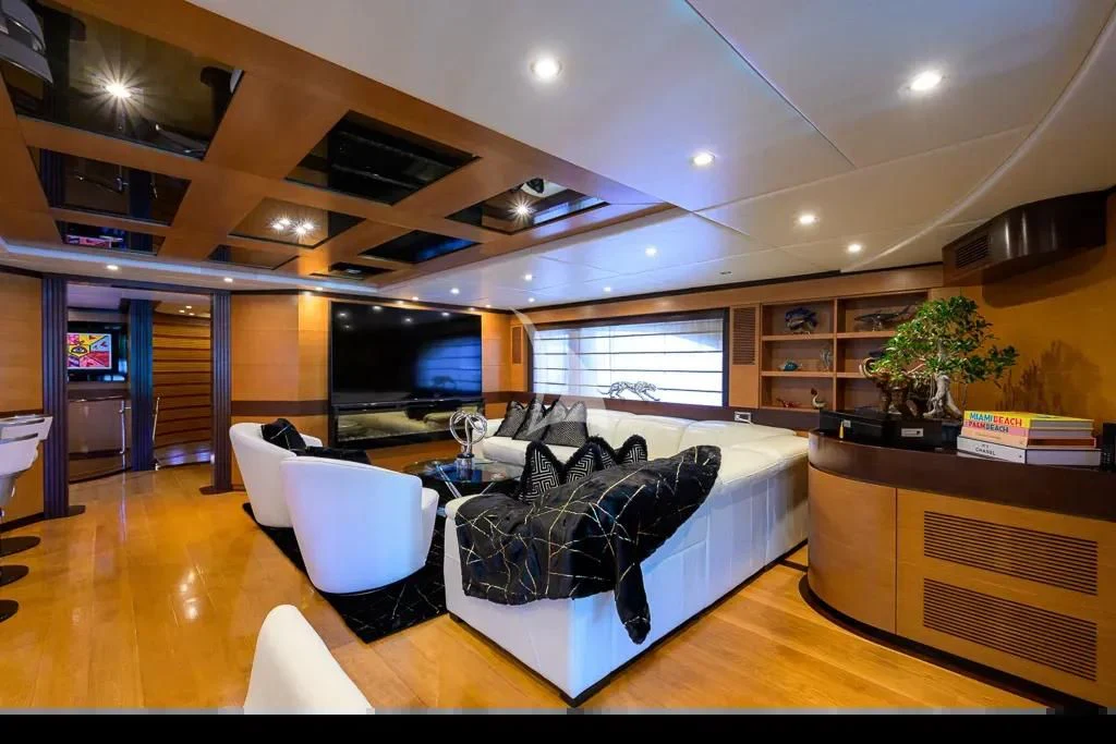 a large living room with a large screen aboard KIMBERLIE Yacht for Sale