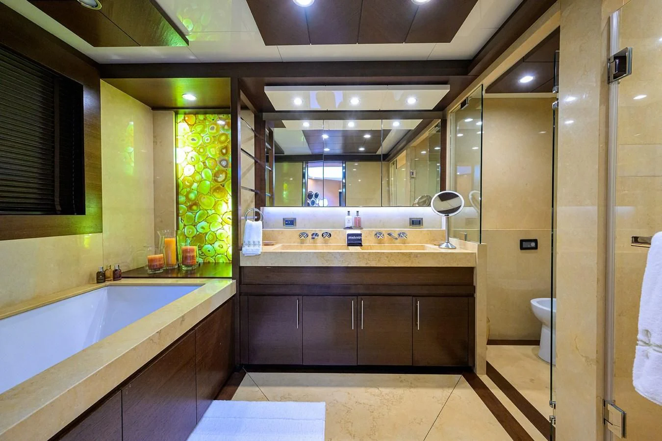 a bathroom with a tub sink and cabinets aboard KIMBERLIE Yacht for Sale