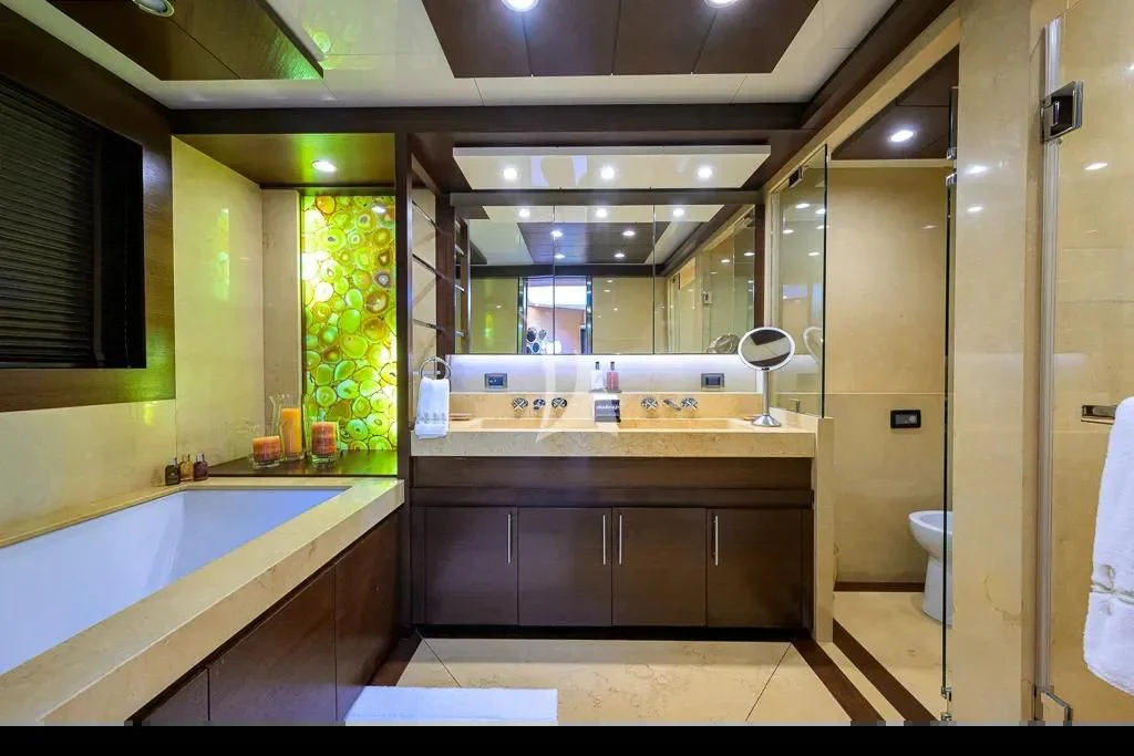 a bathroom with a tub sink and cabinets aboard KIMBERLIE Yacht for Sale