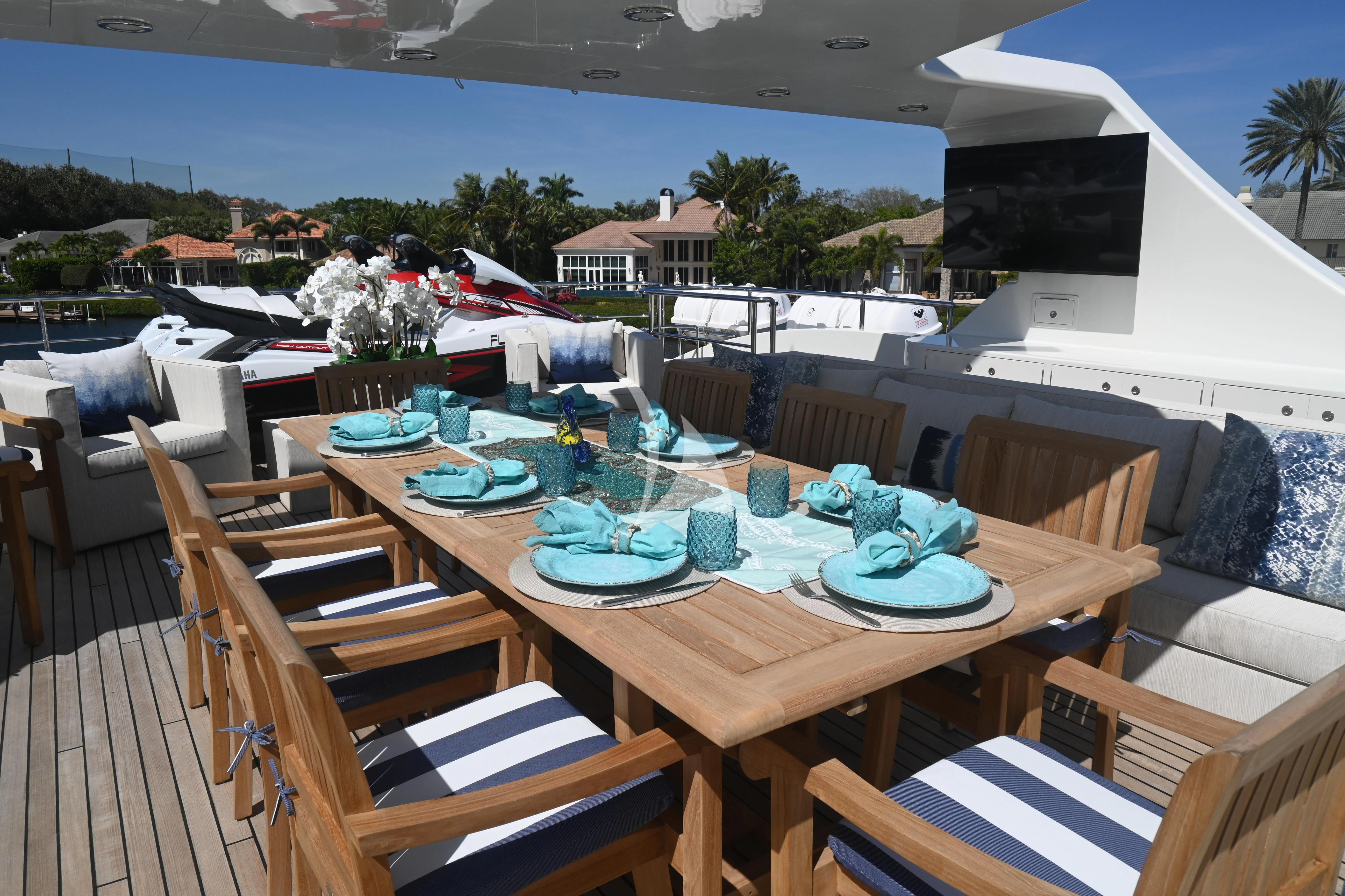 a table set with plates and chairs aboard KIMBERLIE Yacht for Sale