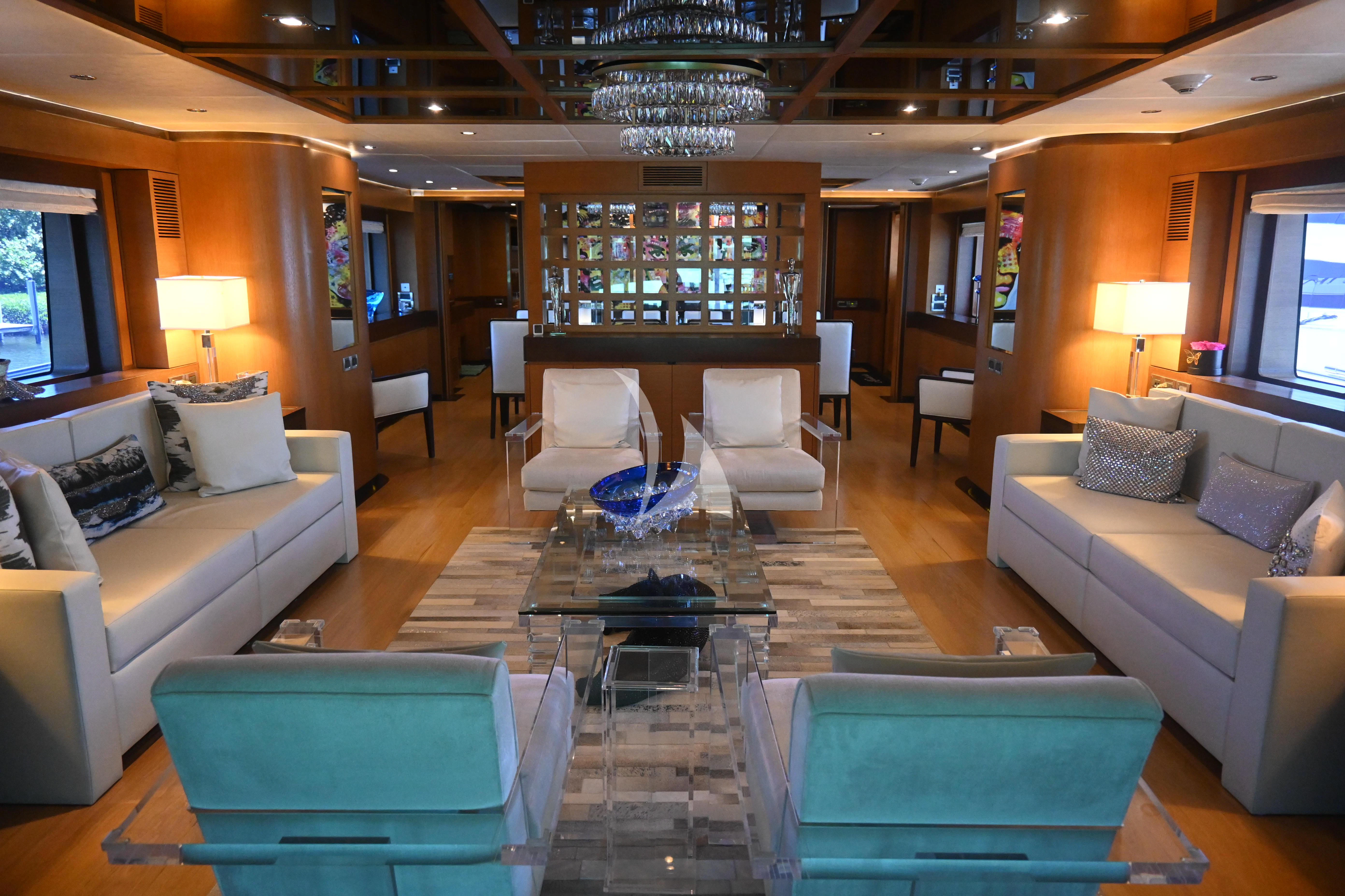 a living room with a large chandelier aboard KIMBERLIE Yacht for Sale