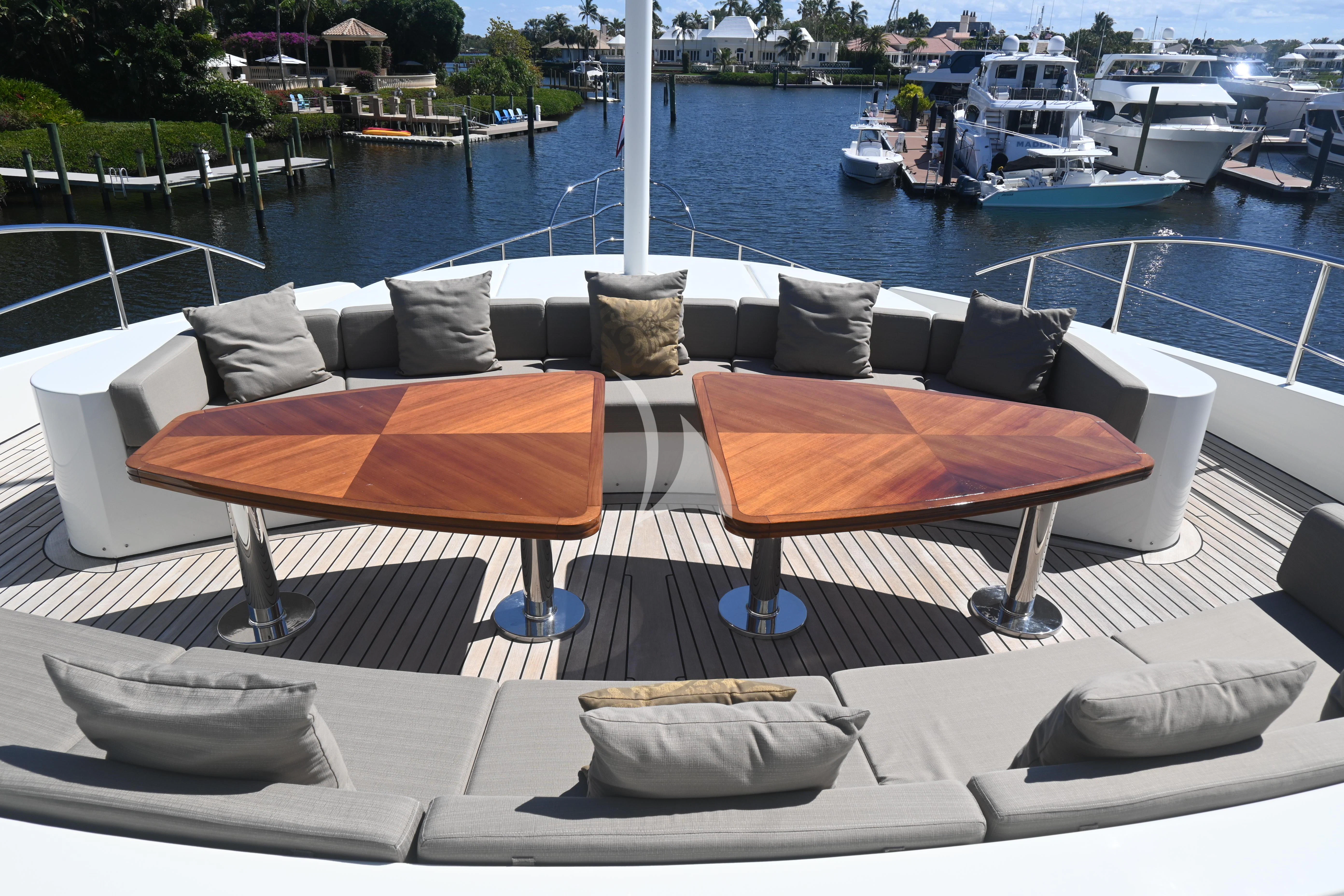 a couple of lounge chairs on a deck overlooking a marina aboard KIMBERLIE Yacht for Sale