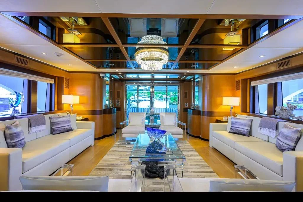 a living room with a large chandelier aboard KIMBERLIE Yacht for Sale