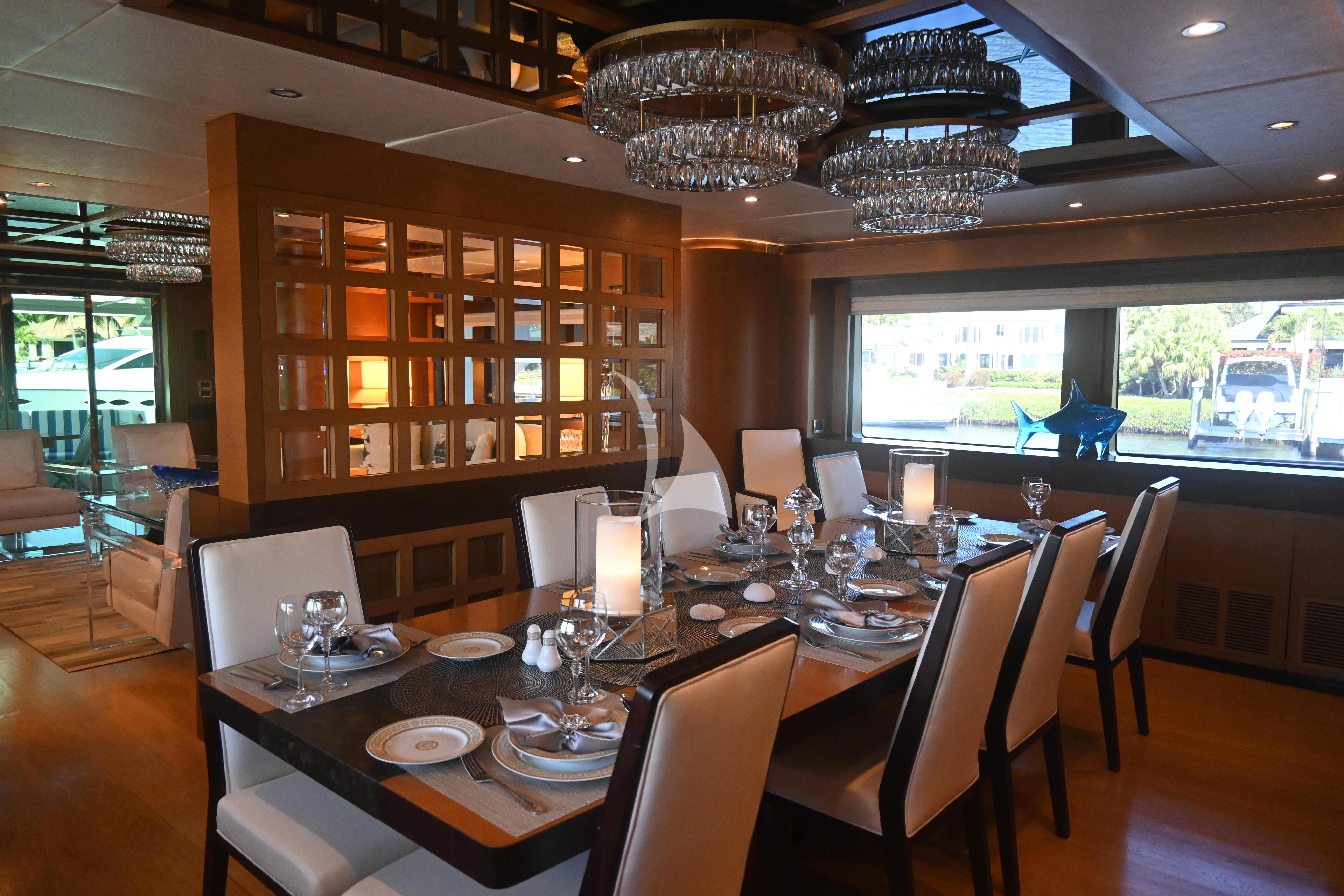 a dining room with a large chandelier aboard KIMBERLIE Yacht for Sale