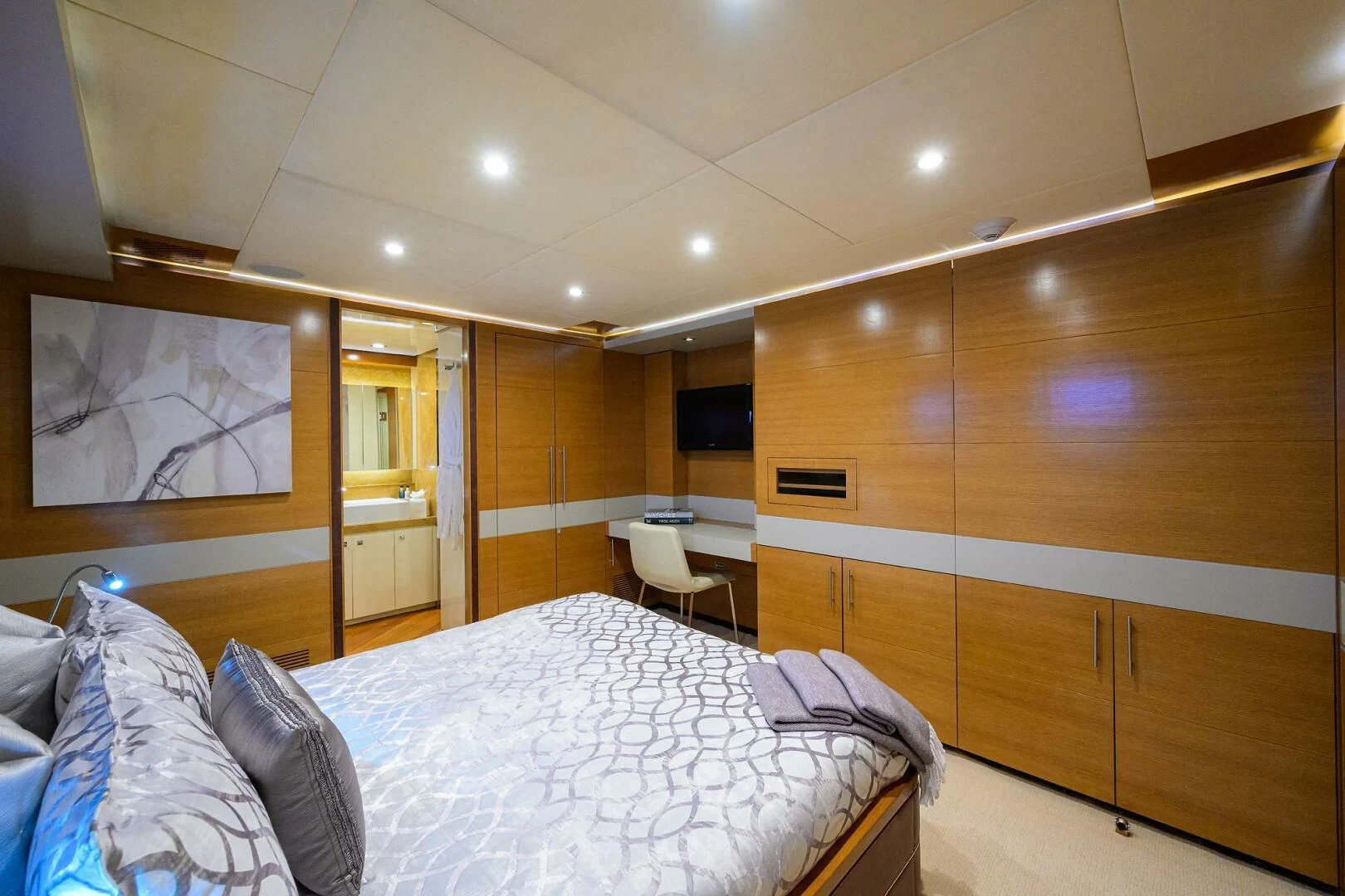 a bedroom with a bed and a desk aboard KIMBERLIE Yacht for Sale