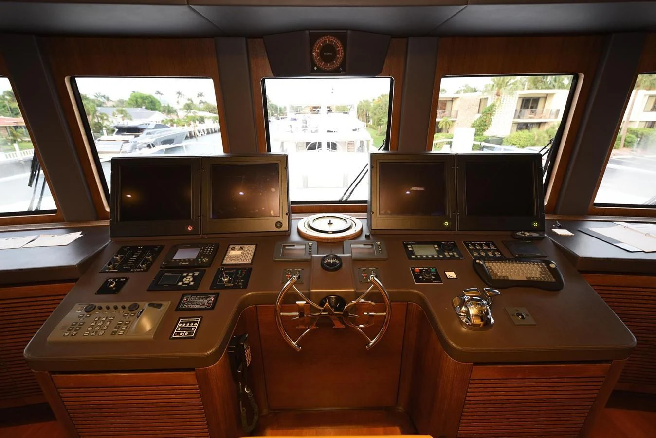 a group of computer monitors and a keyboard on a table aboard KIMBERLIE Yacht for Sale