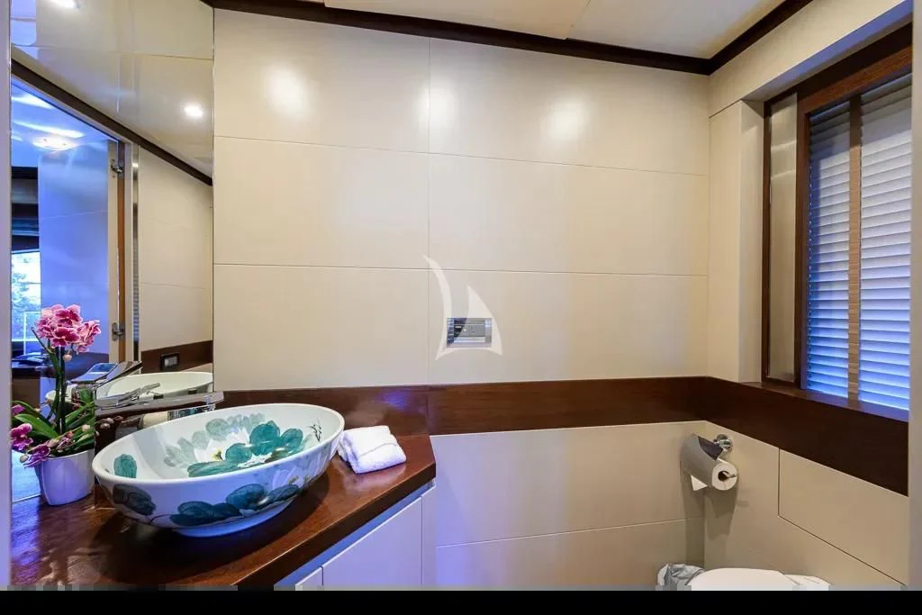 a bathroom with a sink and a mirror aboard KIMBERLIE Yacht for Sale