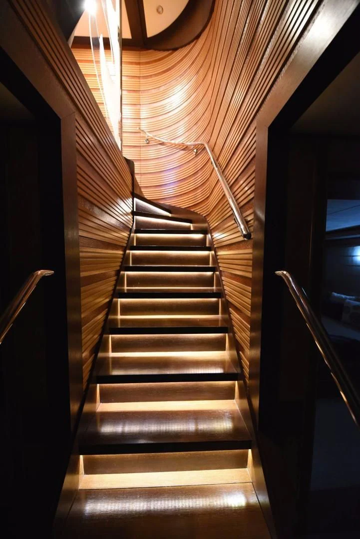 a dark wooden staircase aboard KIMBERLIE Yacht for Sale