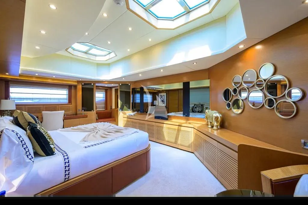 a room with a bed and a large mirror aboard KIMBERLIE Yacht for Sale