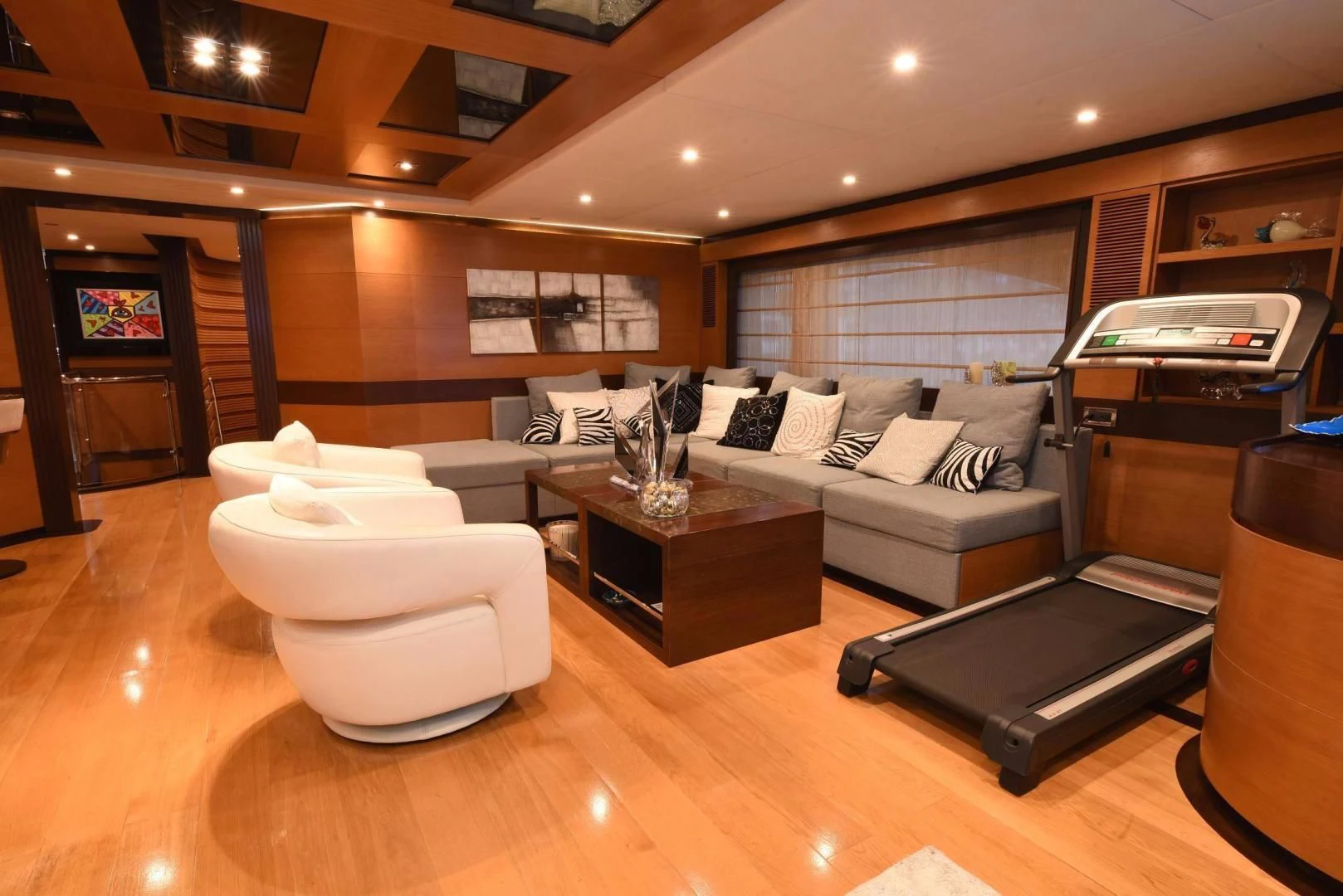 a large living room with a large white couch and a table aboard KIMBERLIE Yacht for Sale