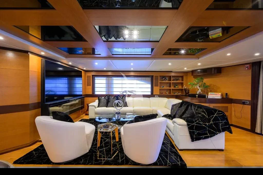 a room with a table chairs and a couch aboard KIMBERLIE Yacht for Sale