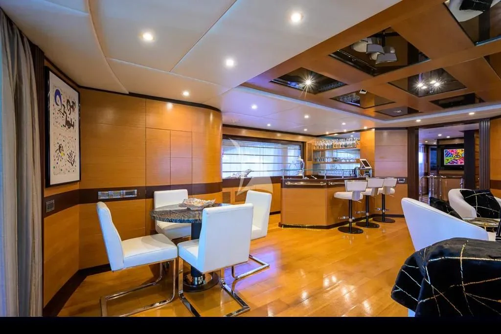 a room with tables and chairs aboard KIMBERLIE Yacht for Sale