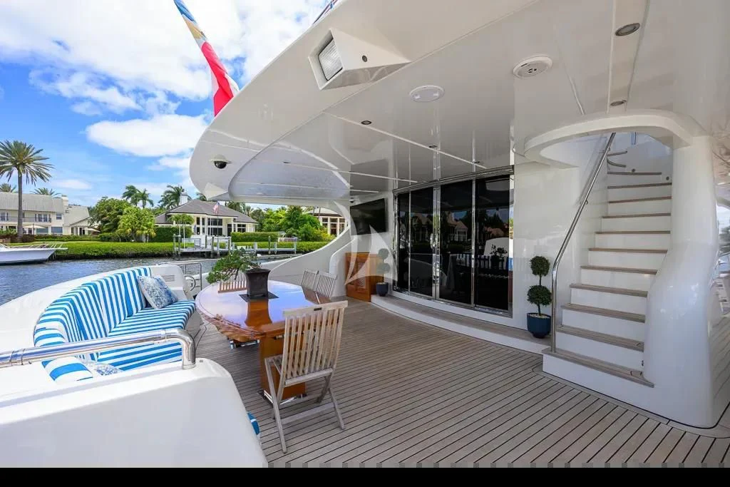 a deck with a pool and a deck with chairs and a table and a pool and trees and aboard KIMBERLIE Yacht for Sale