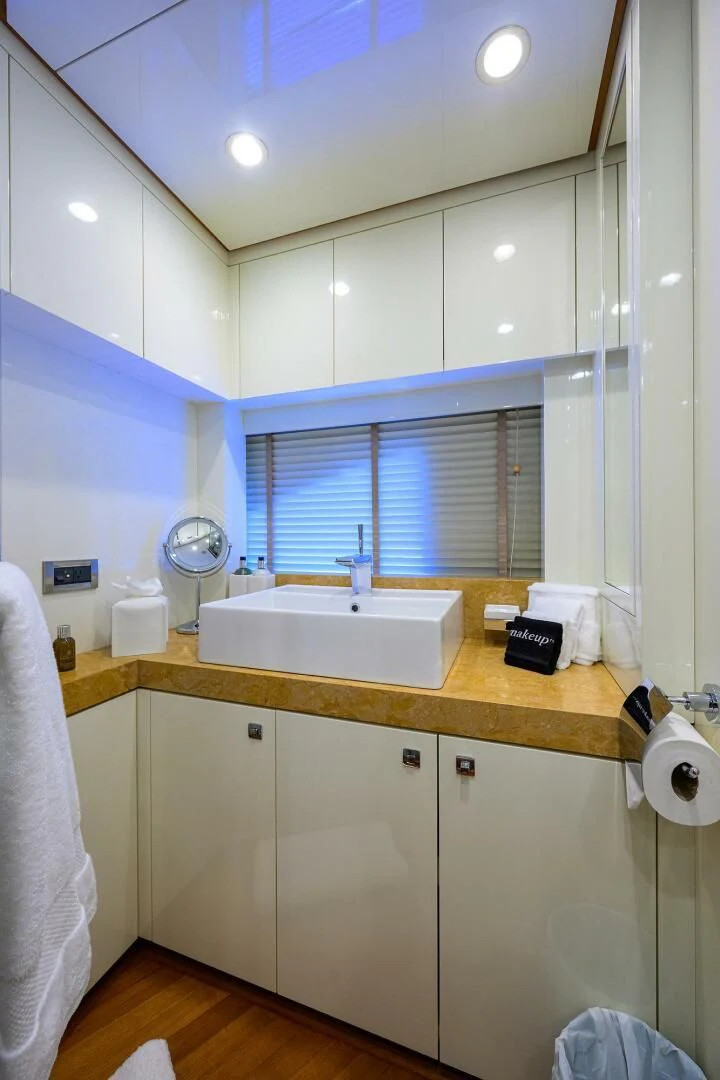 a bathroom with a sink and a window aboard KIMBERLIE Yacht for Sale