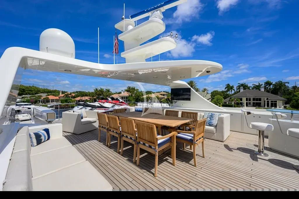 a deck with a table and chairs on it aboard KIMBERLIE Yacht for Sale