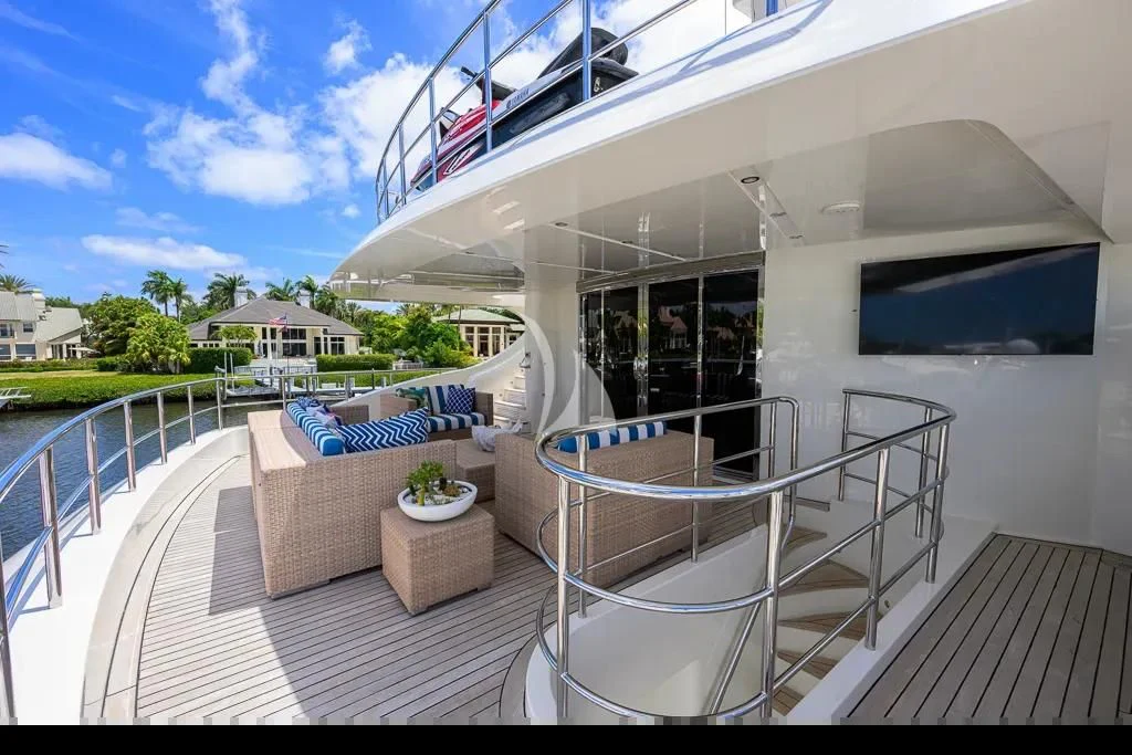 a balcony with a pool and a deck with a house and trees aboard KIMBERLIE Yacht for Sale
