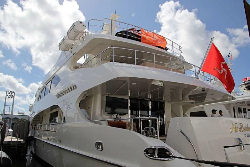 a large white boat with a flag on the front aboard KIMBERLIE Yacht for Sale